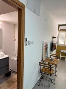 a room with a table and a bathroom with a sink at מגדל חי 1 in Eilat