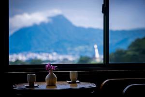 a table with a vase with a flower on it at Okamotoya in Beppu