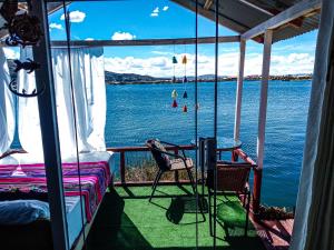 a room with a view of the water on a boat at Sol del Titikaka Lodge in Puno