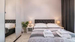 a bedroom with a bed with towels on it at Maya's Flats & Resorts 26 - Panorama View in Gdańsk