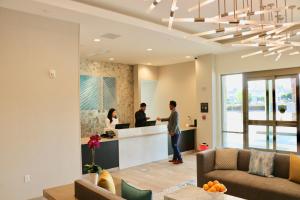 a group of people standing at a counter in a kitchen at Staybridge Suites - Long Beach Airport by IHG in Long Beach +70 photos