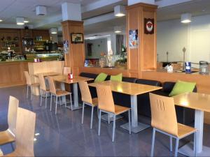 a restaurant with tables and chairs and a counter at Alicante Mar in Alicante