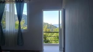 an open door with a window in a room at Sayatri stay in Karsiyang