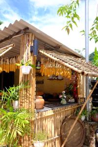 a wooden house with a bunch of hanging utensils at The Bare Nest Retreat in Làng Lai