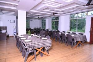 a large room with tables and chairs in it at The Nature's Nest in Attigundi