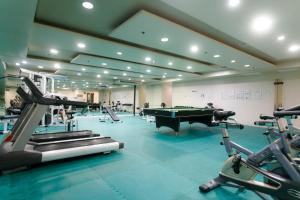 a gym with a pool table and exercise equipment at LivStudios Manila Bay in Manila