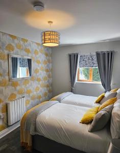 a bedroom with two beds with yellow pillows at Brogans Apartment in Trim