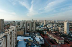 a view of a city with many tall buildings at LivStudios Manila Bay in Manila