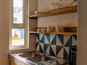 a kitchen with a sink and a window at Bigarade sur Mer  +80 photos