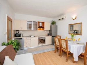 a kitchen and dining room with a table and chairs at Stella with pool & heated jacuzzi in Zmijavci
