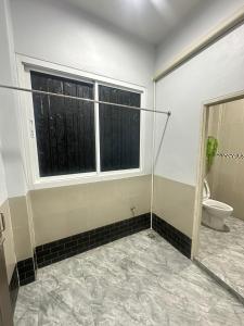 a bathroom with a toilet and a window at LikeHome สมุทรสาคร ปากทางแพ้ว in Ban Khlong Su +5 photos