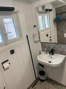 a small bathroom with a sink and a mirror at La maison du pêcheur in Dolus d'Oléron +25 photos