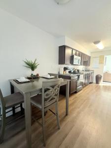 a kitchen with a table and chairs in a room at Luxe, Family Friendly, Spacious & Private Entrance in Addison