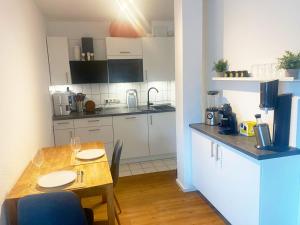 a kitchen with a table and a dining room at Comfort Apartment in Rösrath in Rösrath