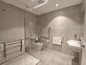 a bathroom with a shower and a toilet and a sink at Studio in heart of Roseville in Sydney +11 photos
