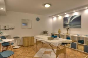 a dining room with a white table and chairs at Waldhotel Wandlitz in Wandlitz