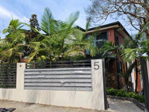 a house with a gate with the number on it at Studio in heart of Roseville in Sydney