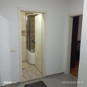 a bathroom with a toilet and a mirror at FushKosov in Kosovo Polje