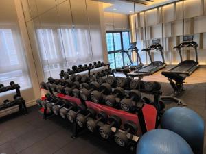 - une salle de sport avec des rames de vélos d'exercice et des tapis roulants dans l'établissement Bukit Bintang Agile Residence TRX, à Kuala Lumpur