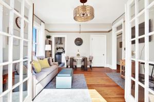 a living room with a couch and a table at Downtown at the Derenne in Savannah +42 photos