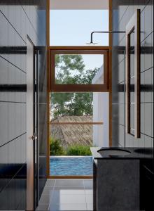a kitchen with a large window and a sink at vrihee resort in Weligama
