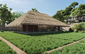 a large grass hut with a field of crops at vrihee resort in Weligama