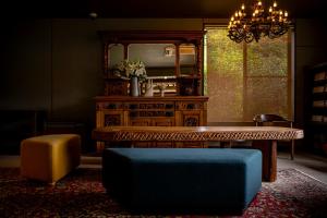 a living room with a table and a mirror at Okamotoya in Beppu
