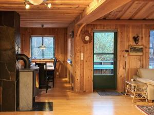 a kitchen and living room with a stove in a cabin at 4 person holiday home in Kjerrgarden in Kjerrgarden