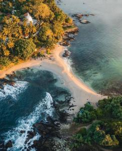 an aerial view of a beach next to the ocean at Baron Nilwella in Dickwella +9 photos