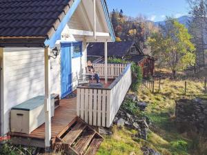 a woman sitting on a porch of a house at 6 person holiday home in Åkra-By Traum in Kyrping +16 photos