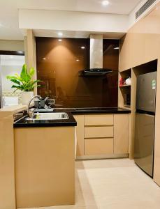 eine Küche mit Spüle und Kühlschrank in der Unterkunft Luxury Apartment with Ocean View - 1 minute to beach in Đà Nẵng