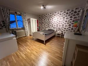 a living room with a bed and a fireplace at Jägaregatan 10 in Tranås