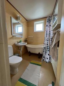 a bathroom with a tub and a toilet and a sink at Jägaregatan 10 in Tranås +9 photos