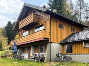 a large wooden house with bikes parked in front of it at 7 person holiday home in STRYN-By Traum in Stryn +19 photos