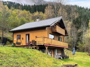 a large wooden cabin on a hill in the woods at 7 person holiday home in STRYN-By Traum in Stryn