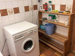 a laundry room with a washing machine and shelves at 7 person holiday home in STRYN-By Traum in Stryn