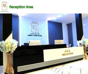 a reception area of a meeting room with flowers in a vase at Herat Star Hotel in Herāt +46 photos