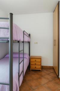 a bedroom with two bunk beds and a dresser at Edelweiss con WIFI y parking in Sierra Nevada +4 photos