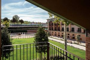 a balcony with a view of a building and a yard at ISSA Resort in Turda