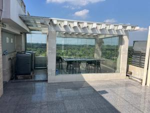 a patio with a table and chairs on a balcony at Hotel Blue Castle International Two in Pāksey