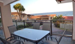 a table and chairs on a balcony with the ocean at Natspat 20 in Margate