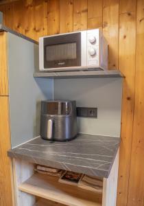a microwave oven sitting on a shelf in a kitchen at ZumHubertus in Bschlabs +78 photos