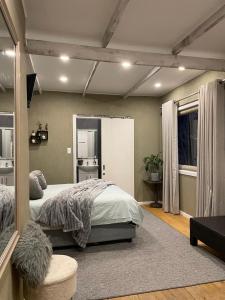 a bedroom with a large bed and a window at Knysna Tranquil 3 Bedroom Cabin in Knysna