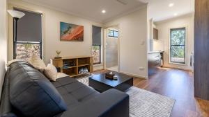 a living room with a couch and a table at 1770 Eco Resort in Agnes Water