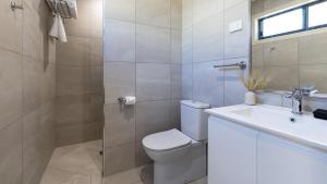 a bathroom with a toilet and a sink and a shower at 1770 Eco Resort in Agnes Water +29 photos