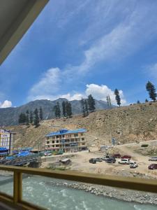 a building on a hill next to a body of water at Beach Resort in Kalām +25 photos