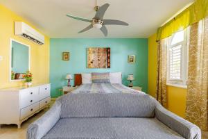 a bedroom with a bed and a ceiling fan at Seacastles by the beach/pool in Montego Bay +202 photos