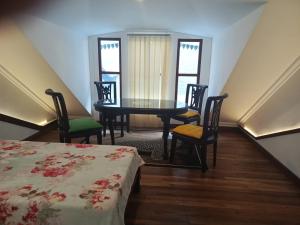 a room with a table and chairs and a table and a bed at Domore Lifestyle in Yogyakarta