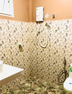 a bathroom with a shower and a toilet at Lucky Sky Homestay ลัคกี้สกายโฮมสเตย์ in Ban Nua