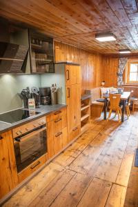 a kitchen with wooden cabinets and a dining room at ZumHubertus in Bschlabs